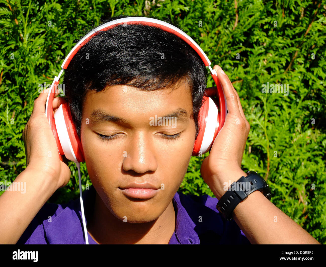 Teenager listening music, boy fifteen old Stock Photo