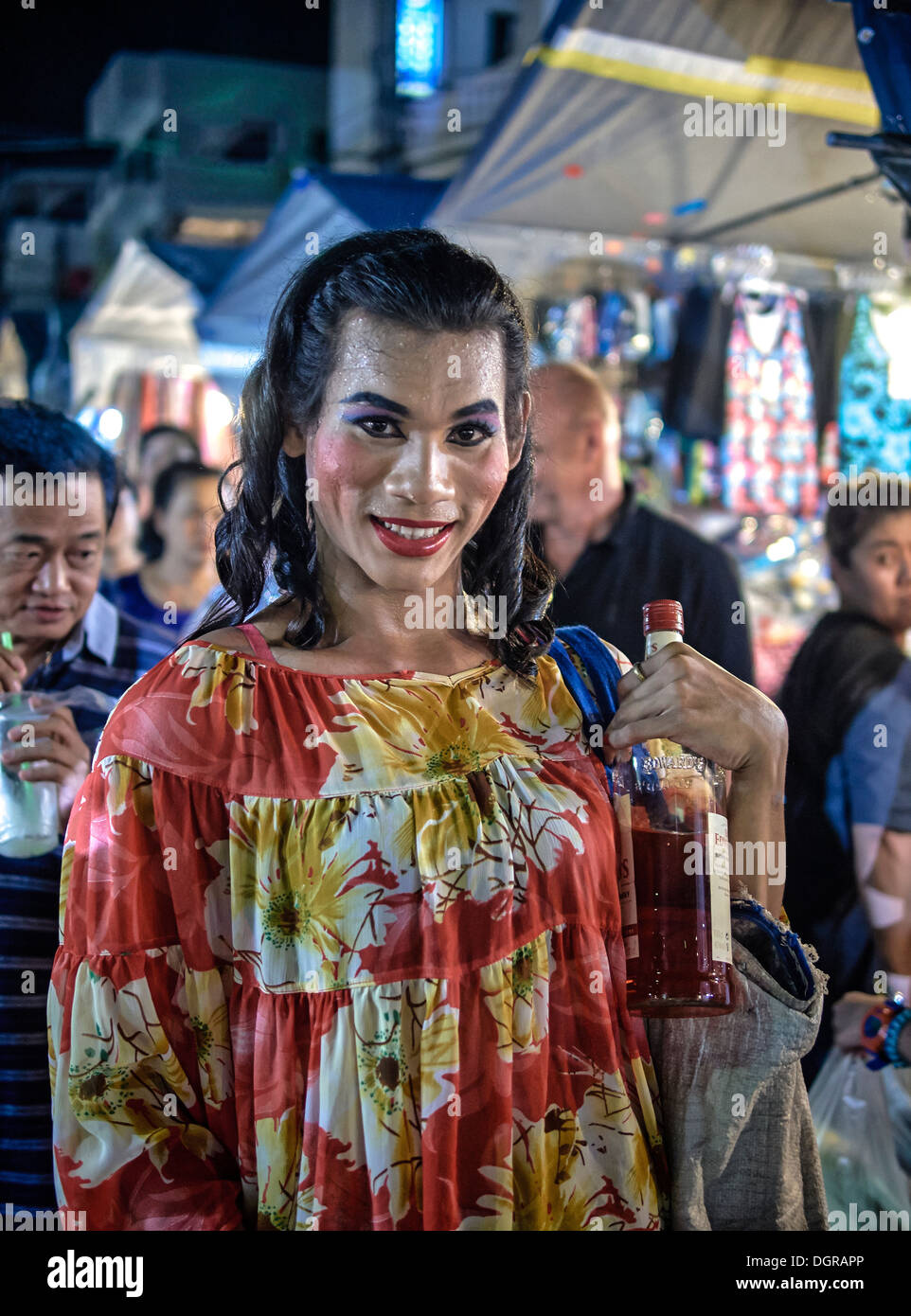 Thailand transsexual selling shots of liquor in the market place. Thailand S. E. Asia Stock Photo