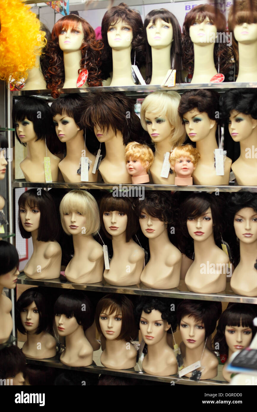 Female mannequins in peruke shop window Stock Photo