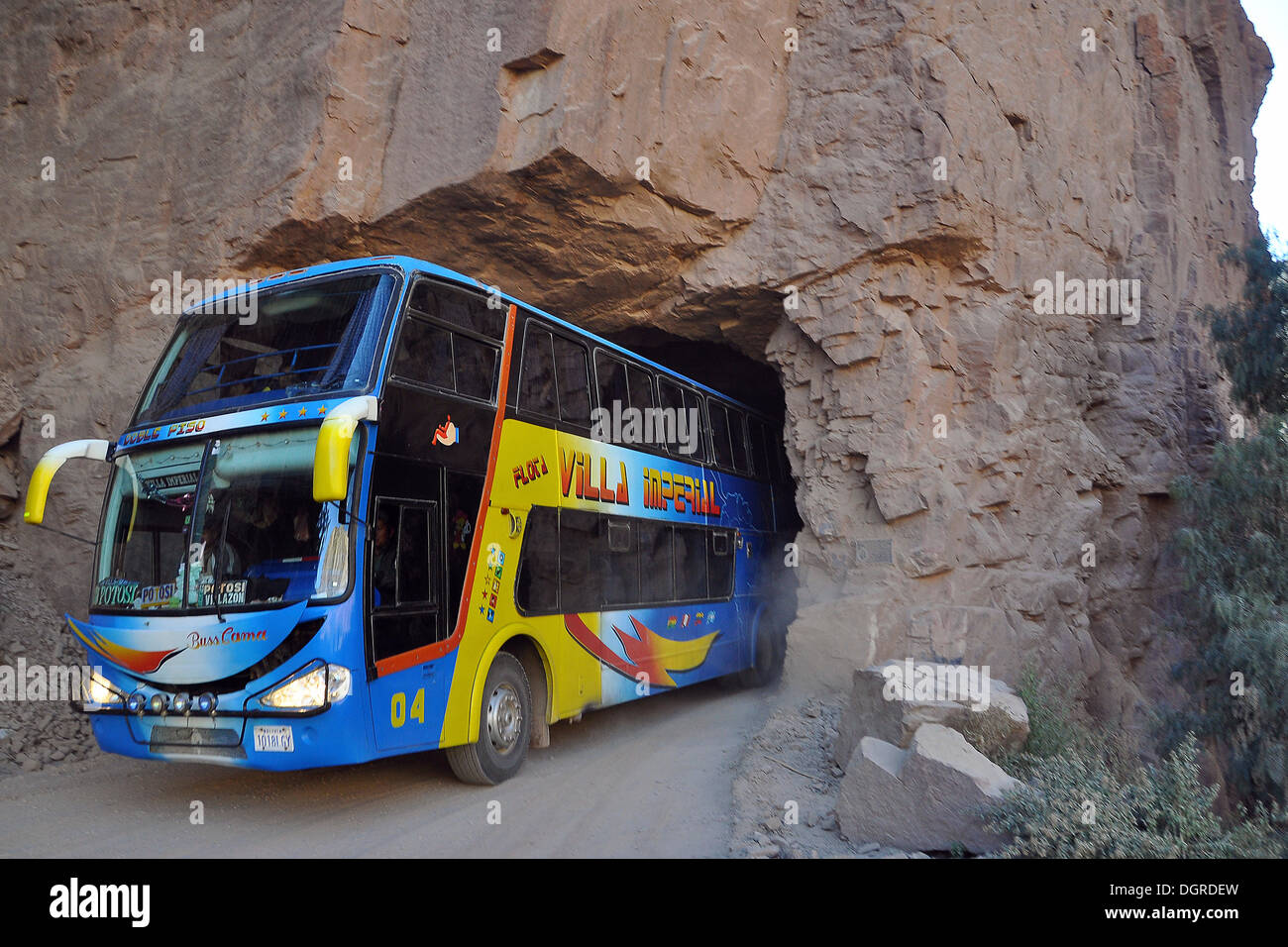 Coach driving through narrow tunnel, Tupiza, Departamento Potosi, Bolivia, South America Stock Photo