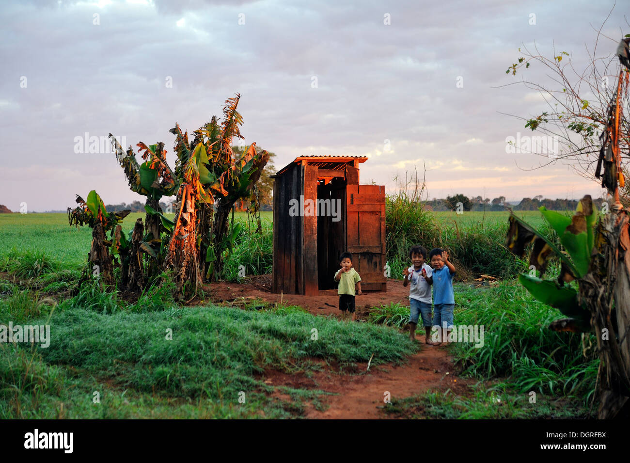 Paraguay, Caaguazu, Jaguary, Guarani boys in front of public toilette Stock Photo