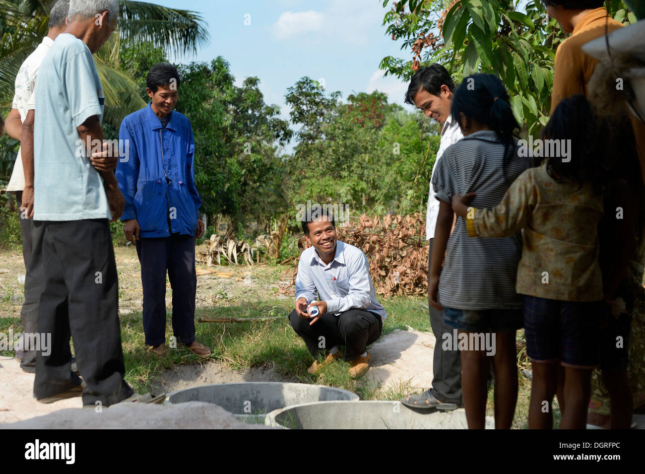 Cambodia, Takeo Province, Members of aid organisation discussing improvements of water supply with villagers Stock Photo