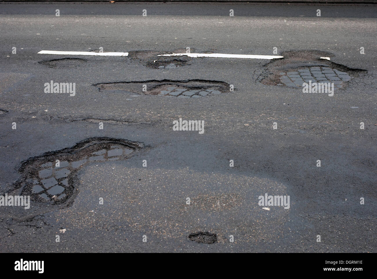 Frost damage, potholes in the road surface, Germany Stock Photo