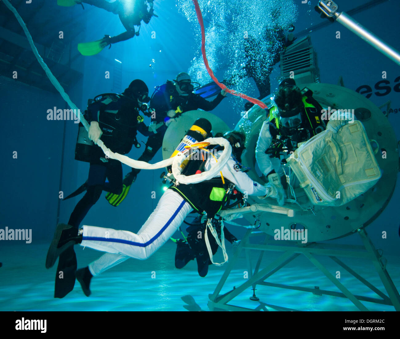 Backup divers and astronauts practicing with a space station module reproduction in a diving basin, European Space Agency, ESA Stock Photo