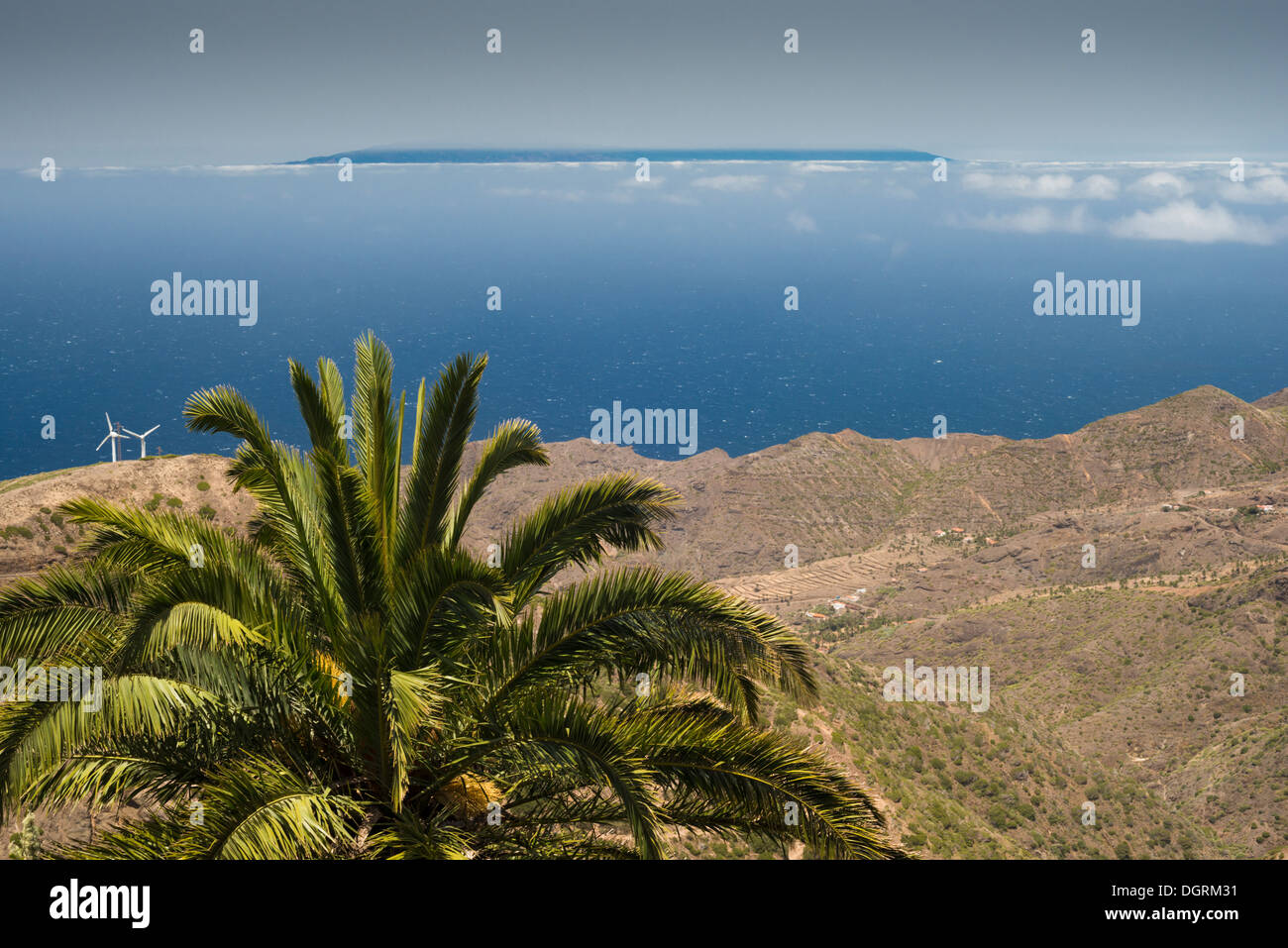 View from Epina, La Gomera, towards La Palma, visible above the ocean and the sea of clouds (mar de nubes) over 60 km away Stock Photo