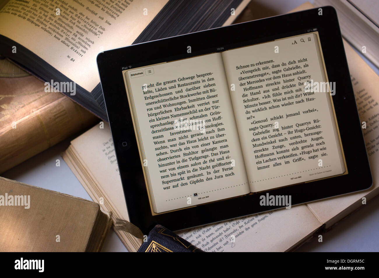 E-book reader beside old books, Germany Stock Photo