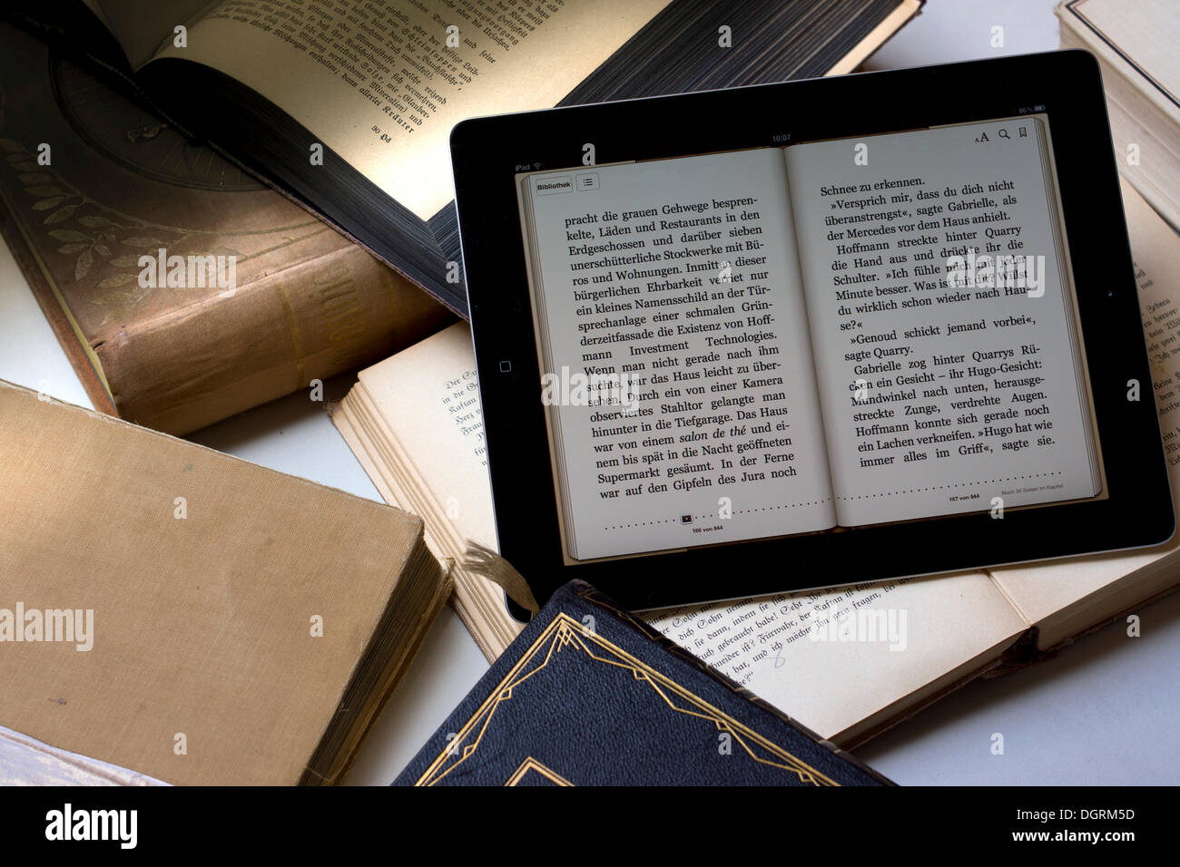 E-book reader beside old books, Germany Stock Photo