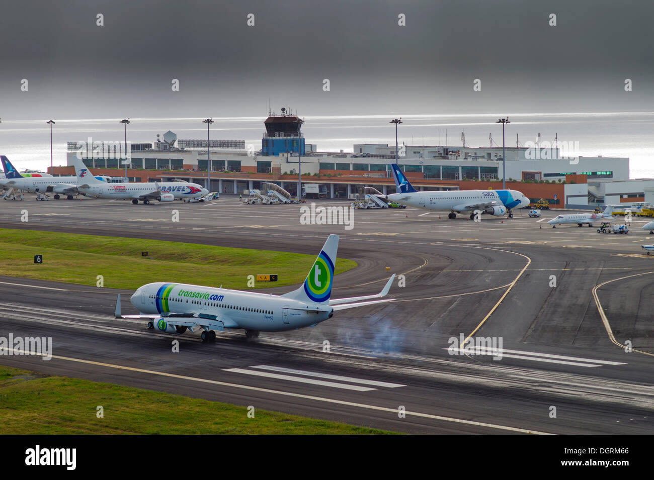 Landing approach of passenger plane of Transavia Airlines at the airport of Madeira during bad weather, LPMA, Funchal Airport or Stock Photo