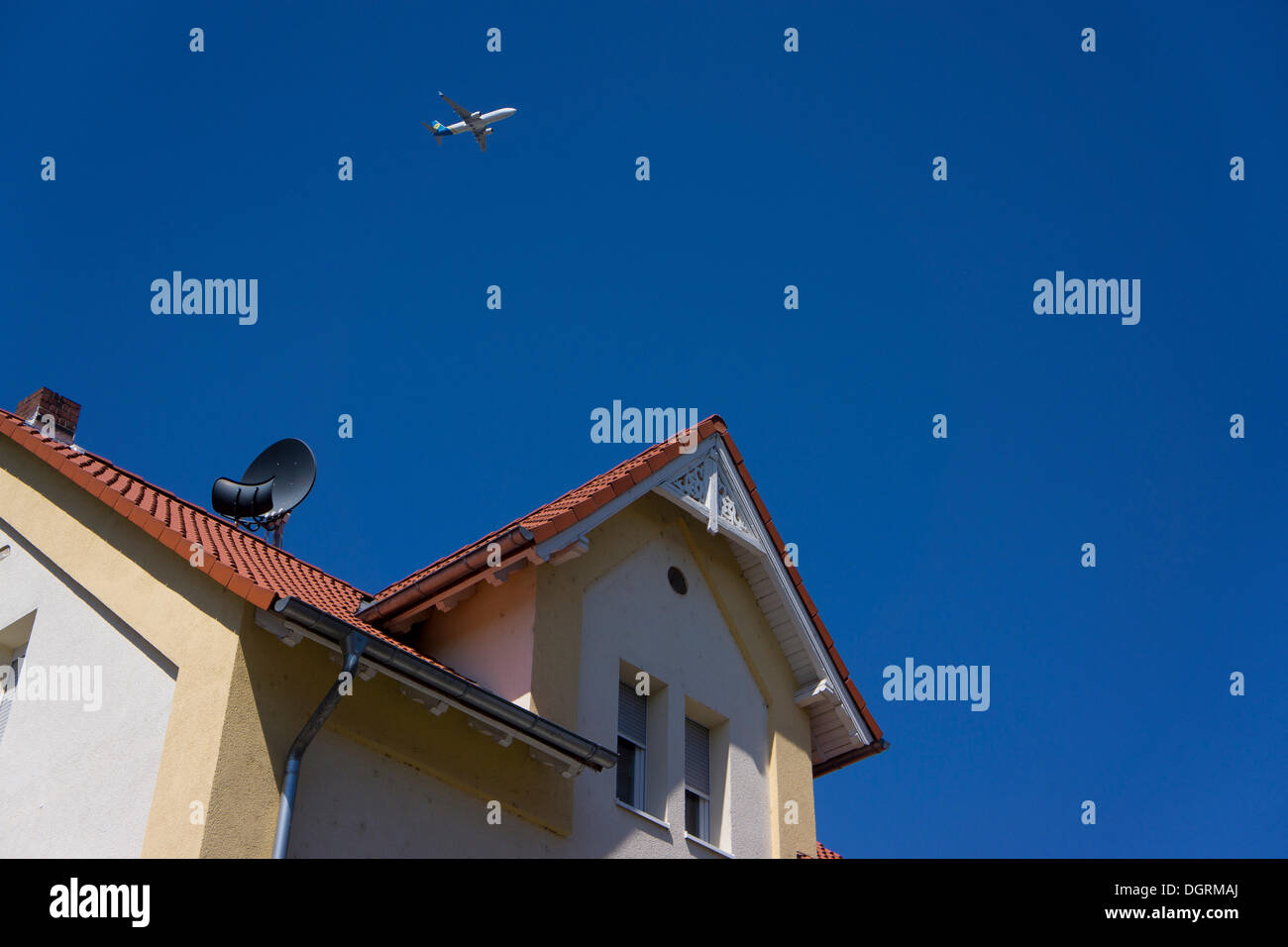 Landing aircraft approaching Frankfurt Airport above a house in Ruesselsheim, Hesse, PublicGround Stock Photo