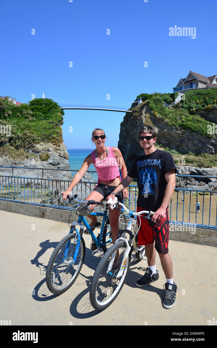 Young couple with bicycles by Towan Beach, Newquay, Cornwall, England, United Kingdom Stock Photo
