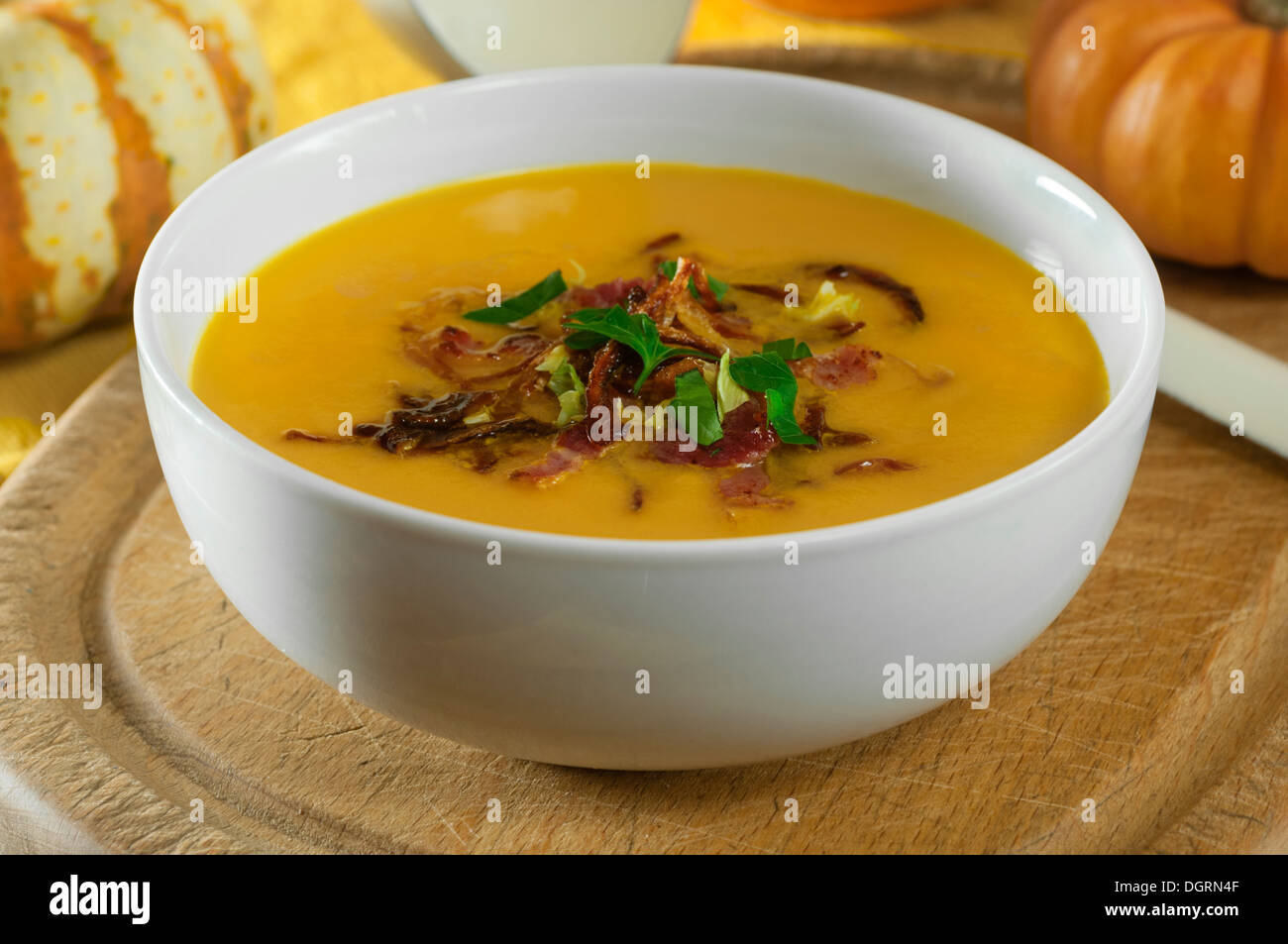 Pumpkin soup with crispy bacon and onions Stock Photo Alamy