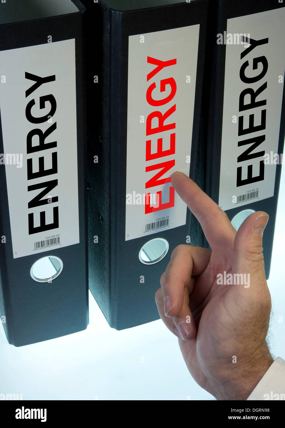 Hand pointing to a ring binder labeled Energy, symbolic image Stock Photo