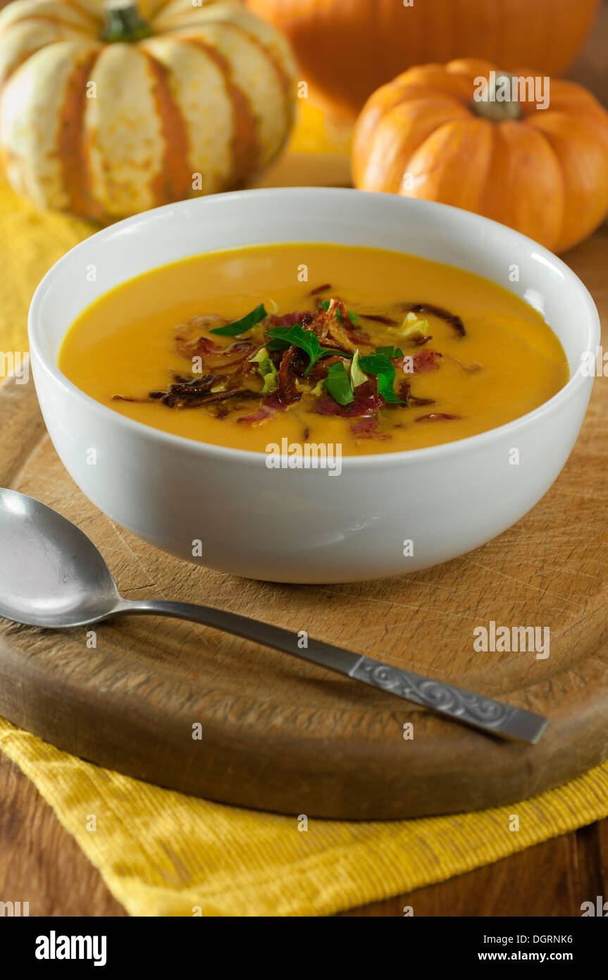 Pumpkin soup with crispy bacon and onions Stock Photo