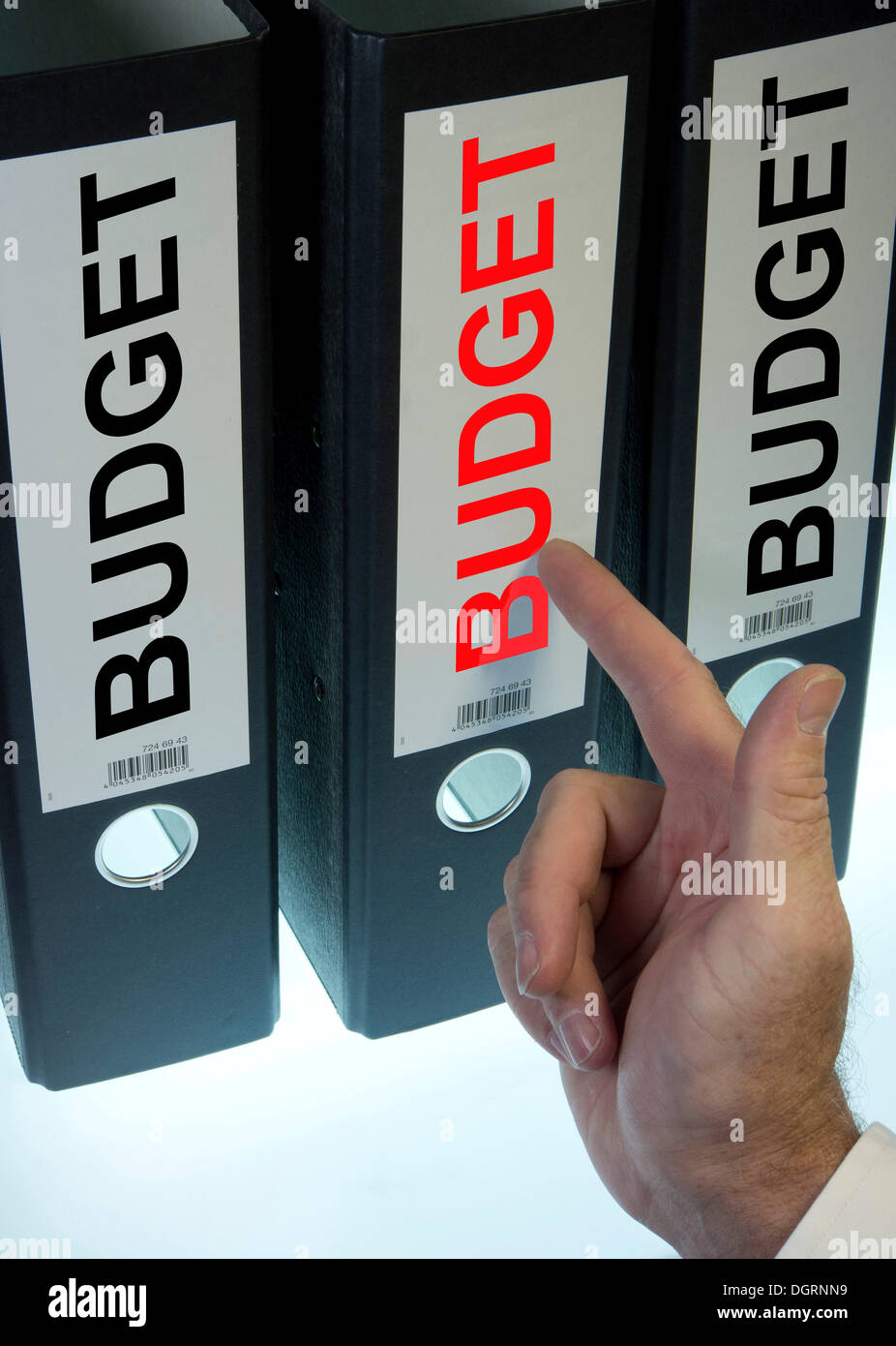 Hand pointing to a ring binder labelled 'BUDGET' Stock Photo