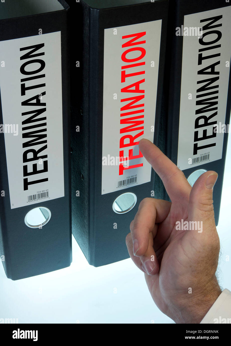 Hand pointing to a ring binder labelled 'TERMINATION' Stock Photo