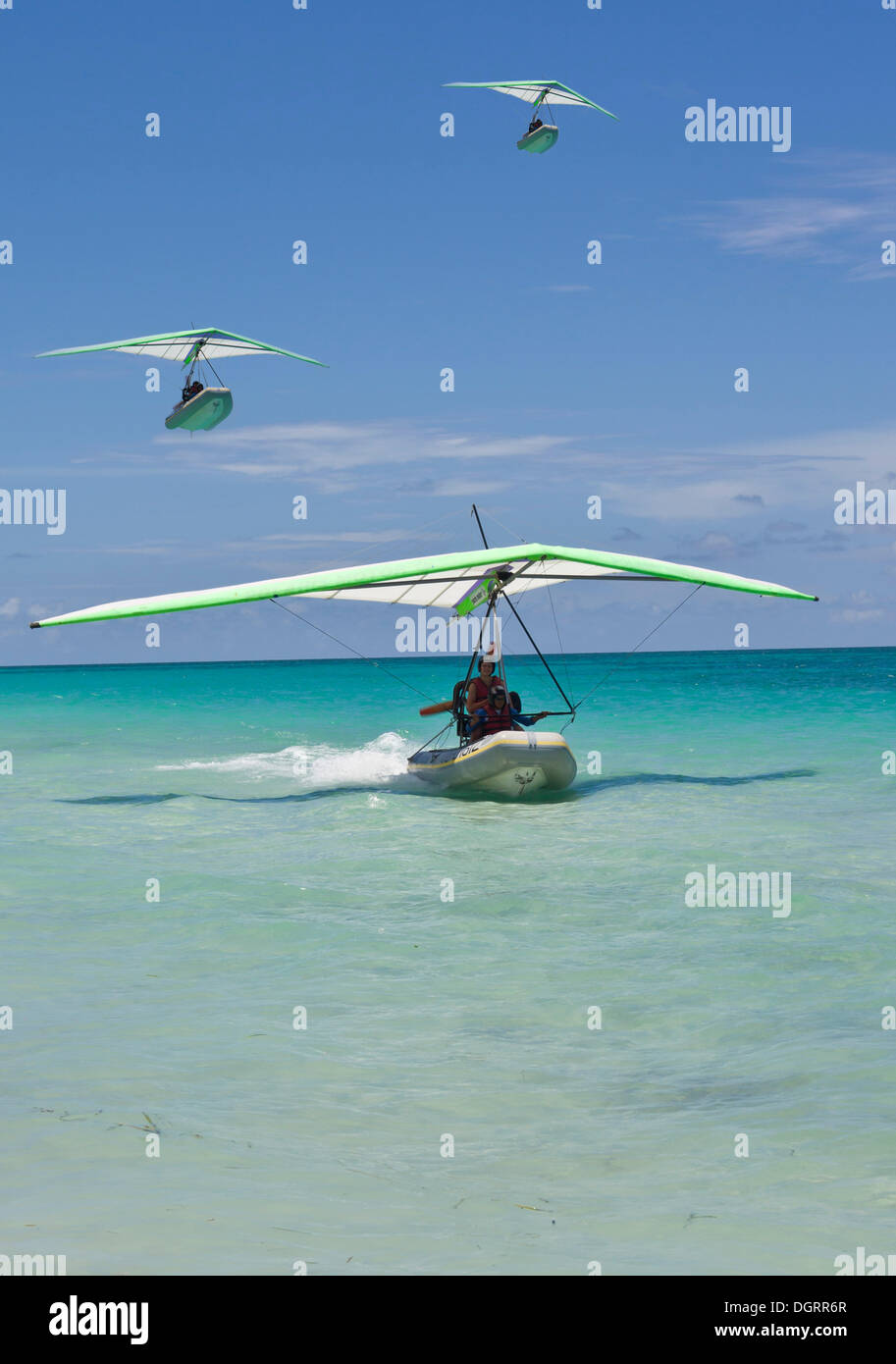 Motorised hang glider landing at sea, with boat, ultralight aircraft, UL trike, Varadero, Cuba, Caribbean, Central America Stock Photo