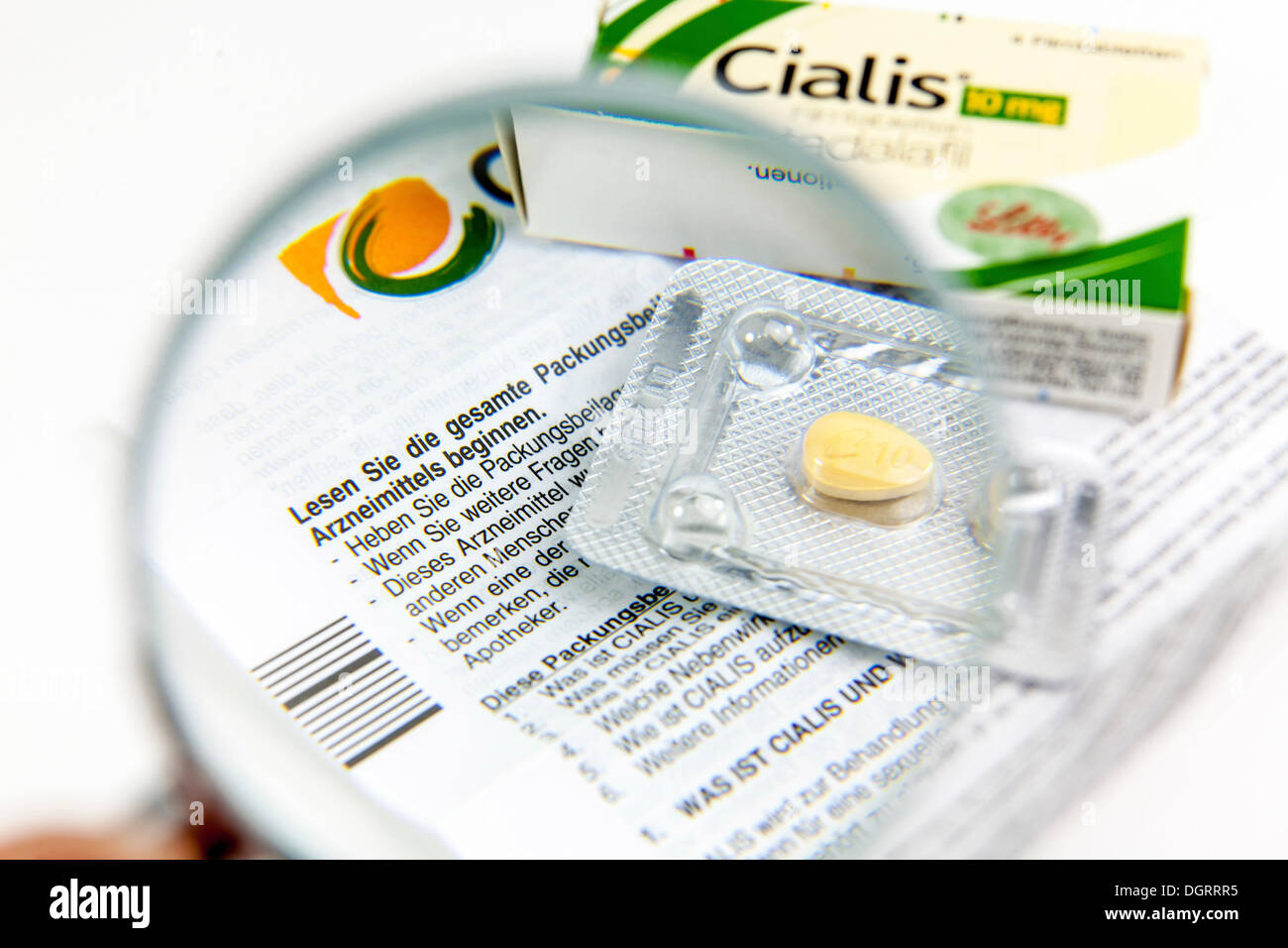 Cialis tablets for increasing virility under a magnifying glass Stock Photo