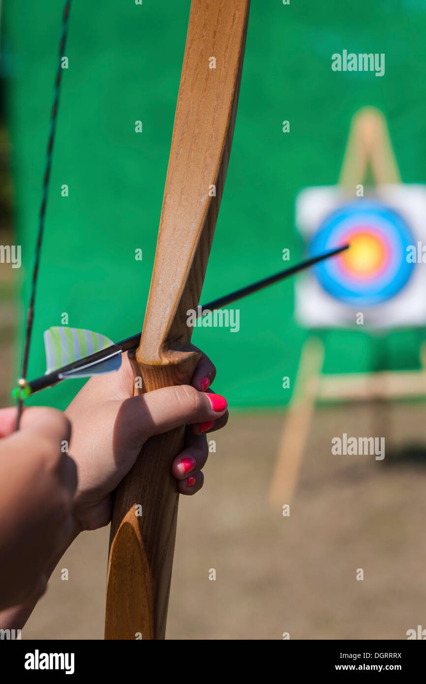 Archer aiming bow and arrow at target, Hesse Stock Photo