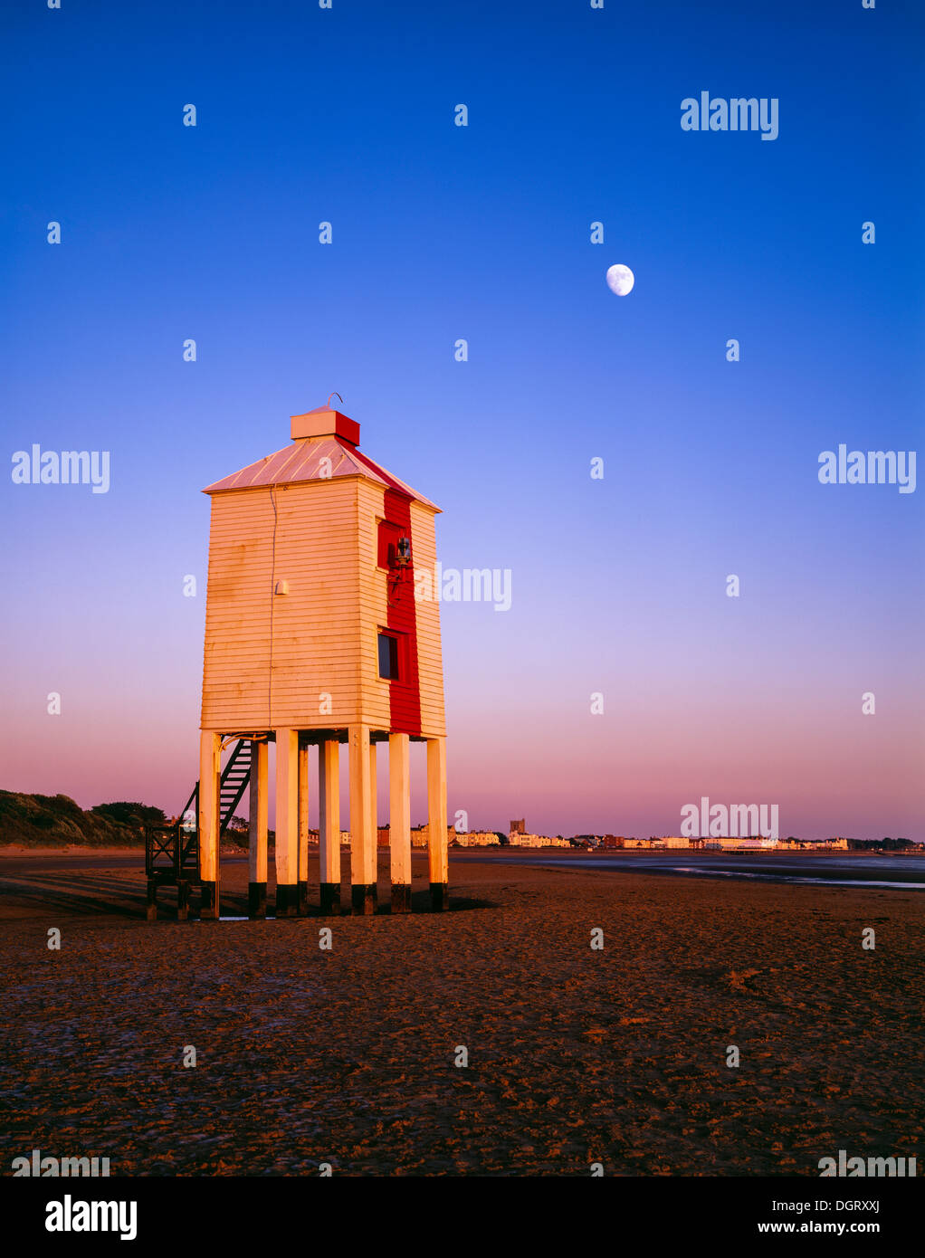 The lighthouse overlooking Bridgwater Bay in the Bristol Channel at Burnham-on-Sea with the Moon overhead. Somerset, England. Stock Photo