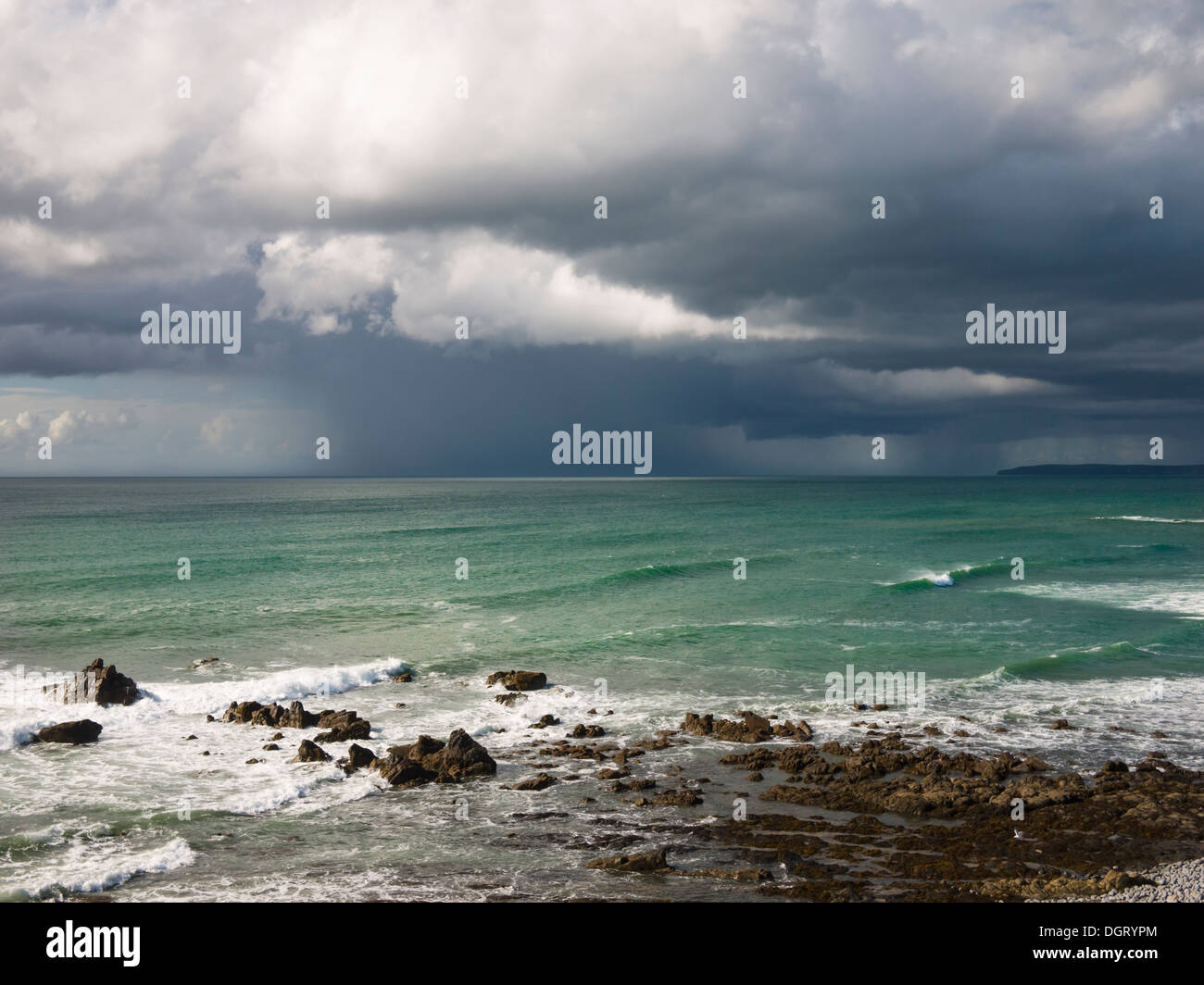 Summer rainstorm over the Atlantic Ocean viewed from Cornborough range on the North Devon coast near Abbotsham, England. Stock Photo