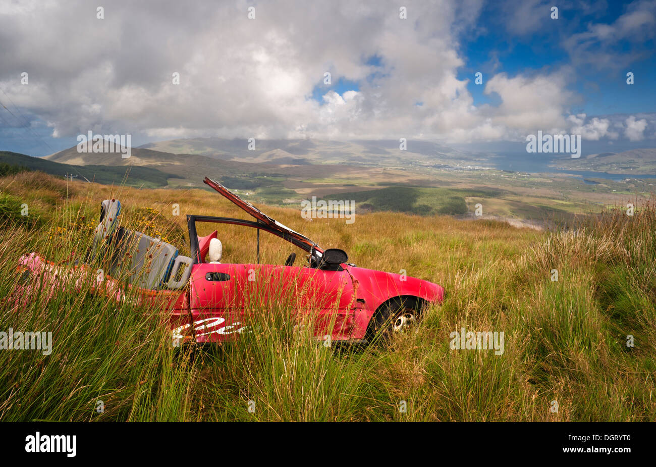 Old car abandoned in the bog at top of Knockoura Mountain, overlooking Bantry Bay, Beara Peninsula, County Cork, Ireland Stock Photo