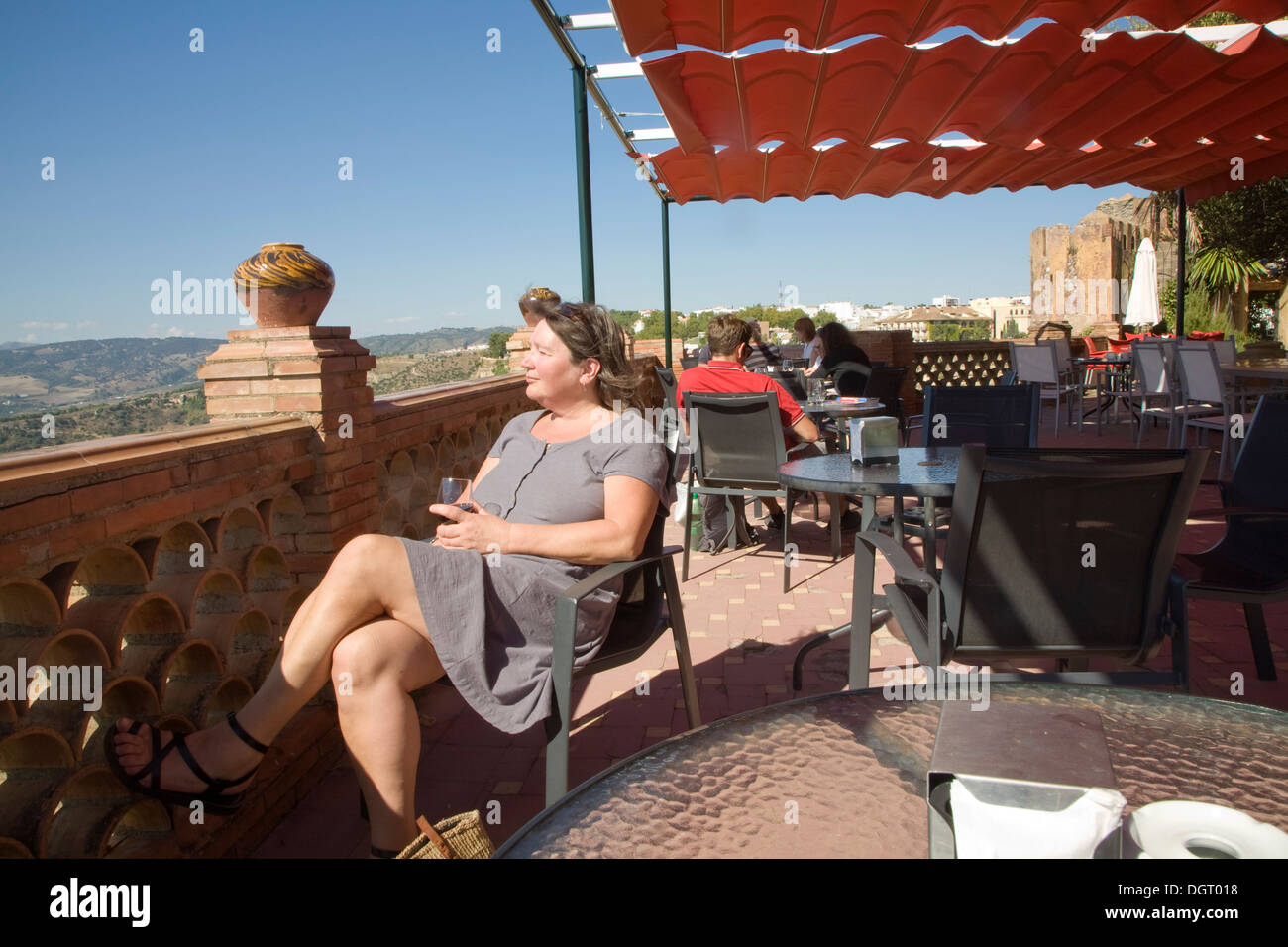 Woman sitting in the sun on a cafe terrace Ronda Spain Stock Photo