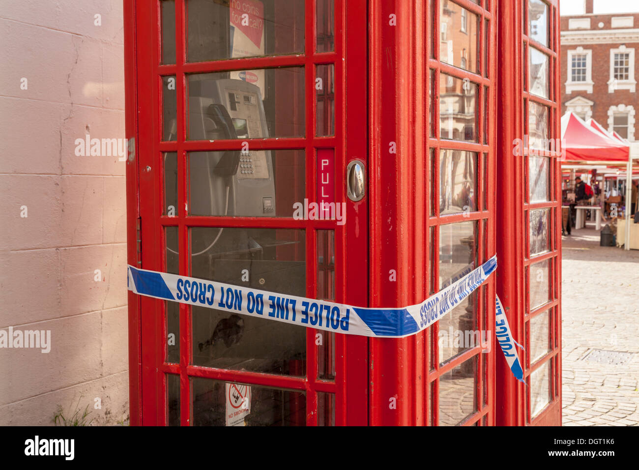 Police tape wrapped around a phone box at a crime scene, Newark on Trent, Nottinghamshire, England, UK Stock Photo