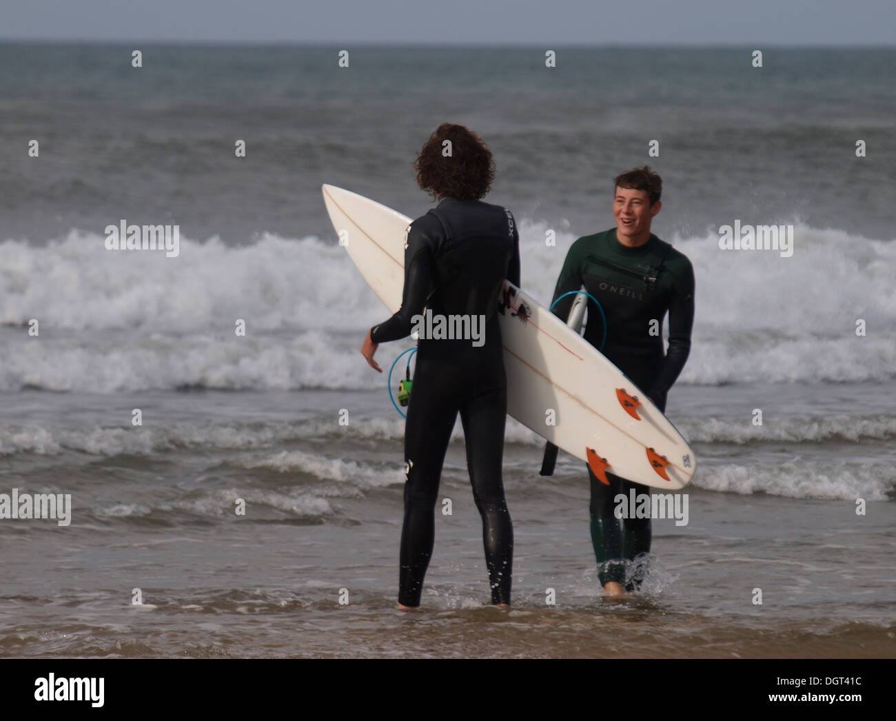Two young adult surfers, Bude, Cornwall, UK Stock Photo