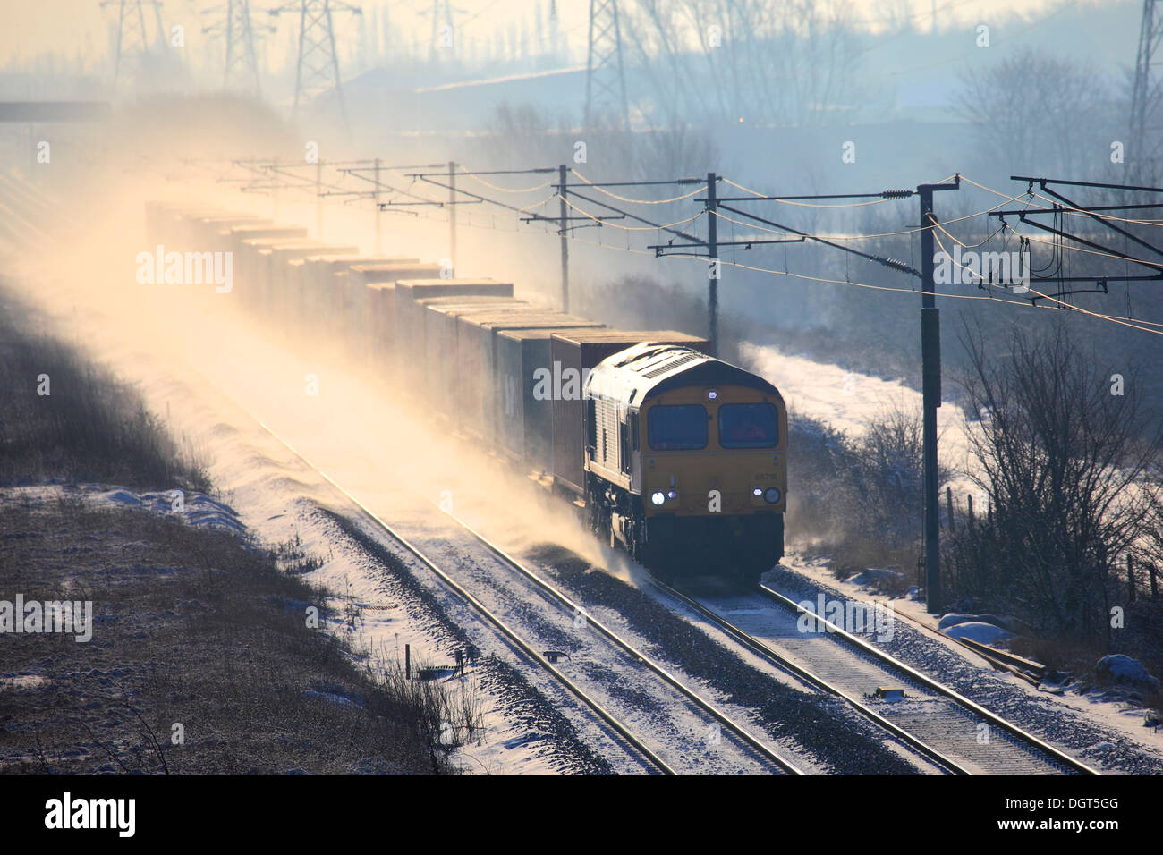 Winter Snow, GBRF Trains 66716 Diesel Freight Train, pulling containers, East Coast Main Line Railway, Cambridgeshire, England Stock Photo