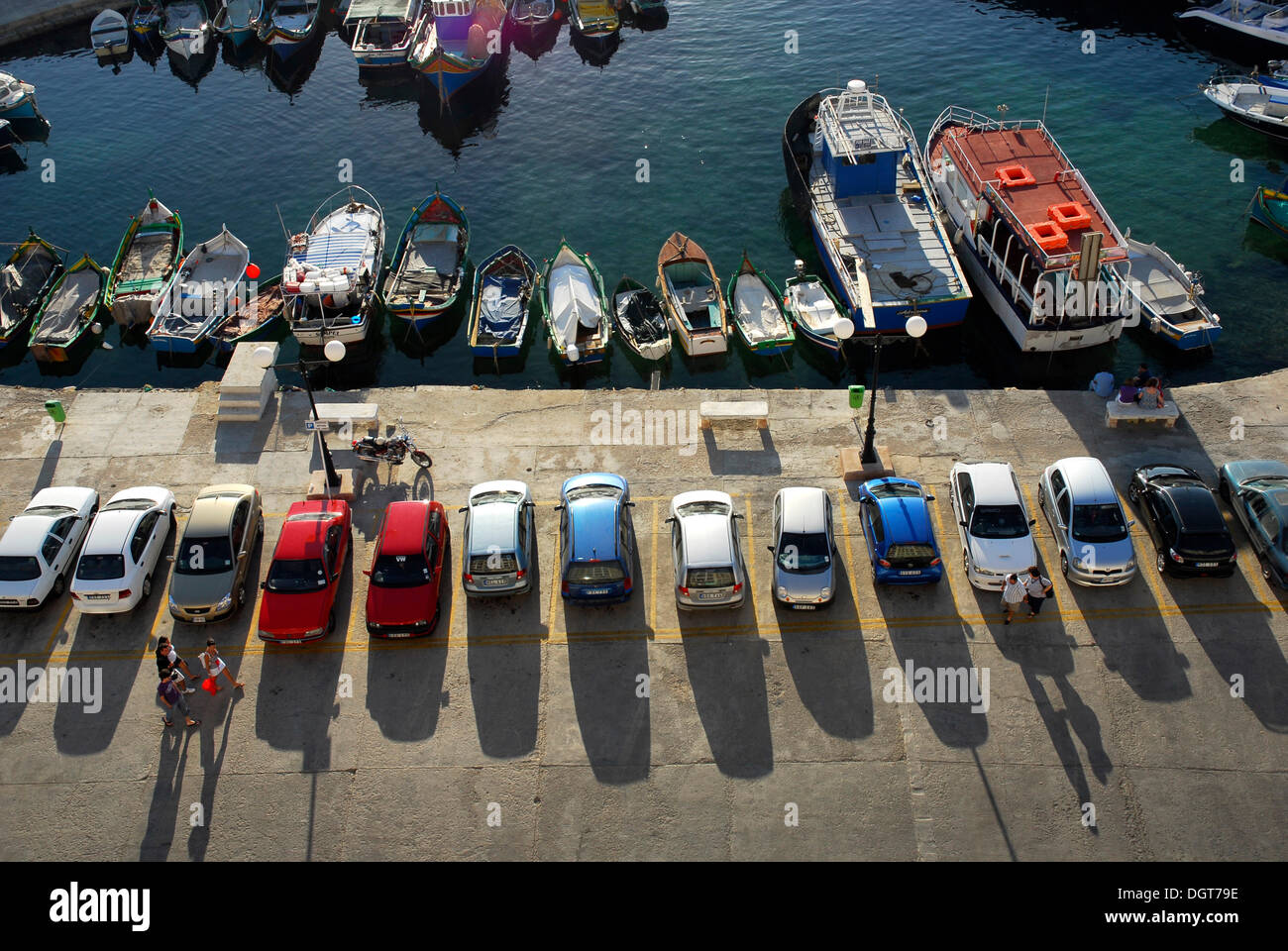 Parked cars and fishing boats in the harbour, Bay of Marsalforn, Marsalforn, Gozo Island, Malta, Mediterranean Sea, Europe Stock Photo