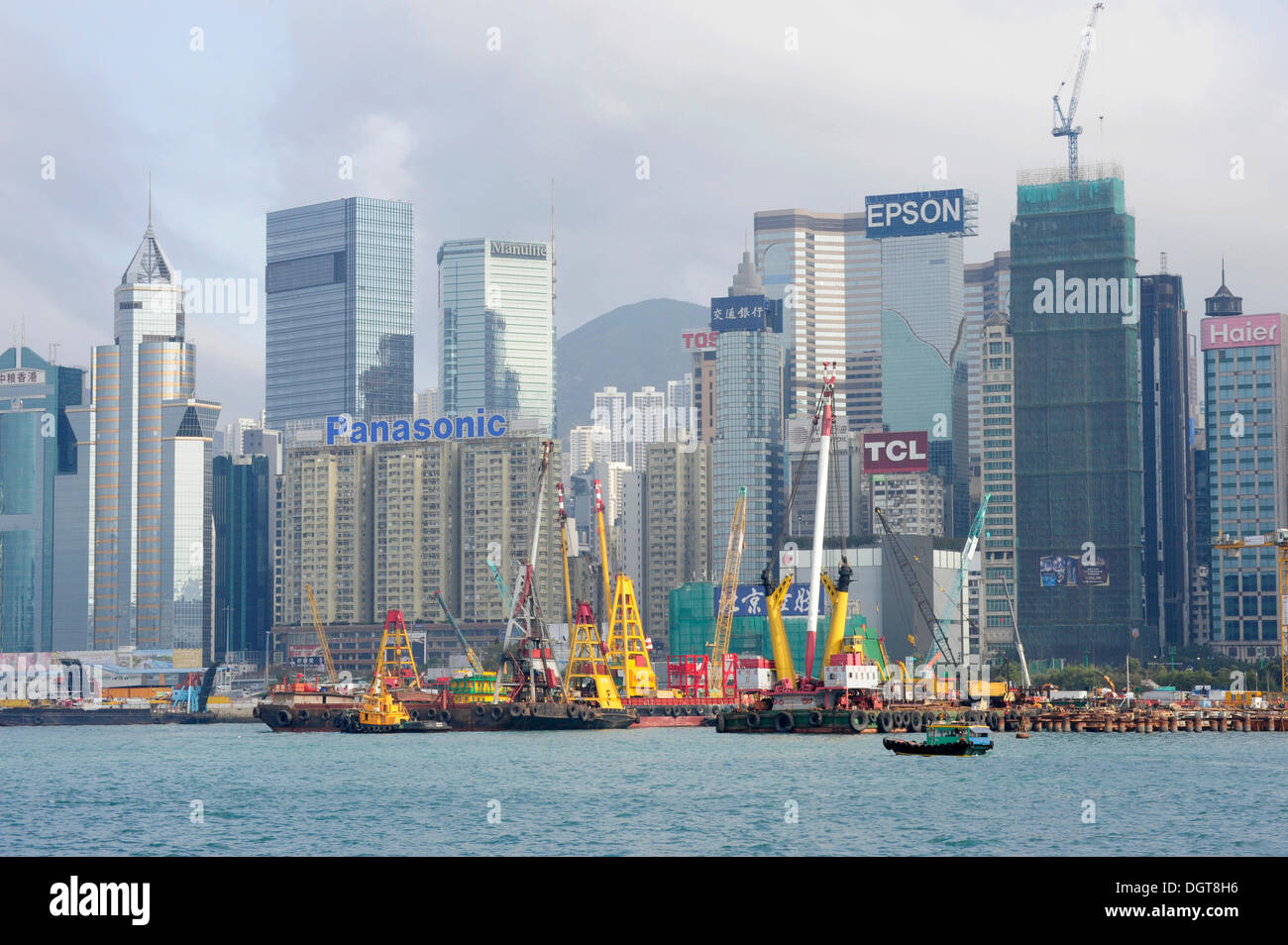 Construction site at the harbour, Victoria Harbour, the skyline with skyscrapers at the back, Wan Chai, Hong Kong Island Stock Photo