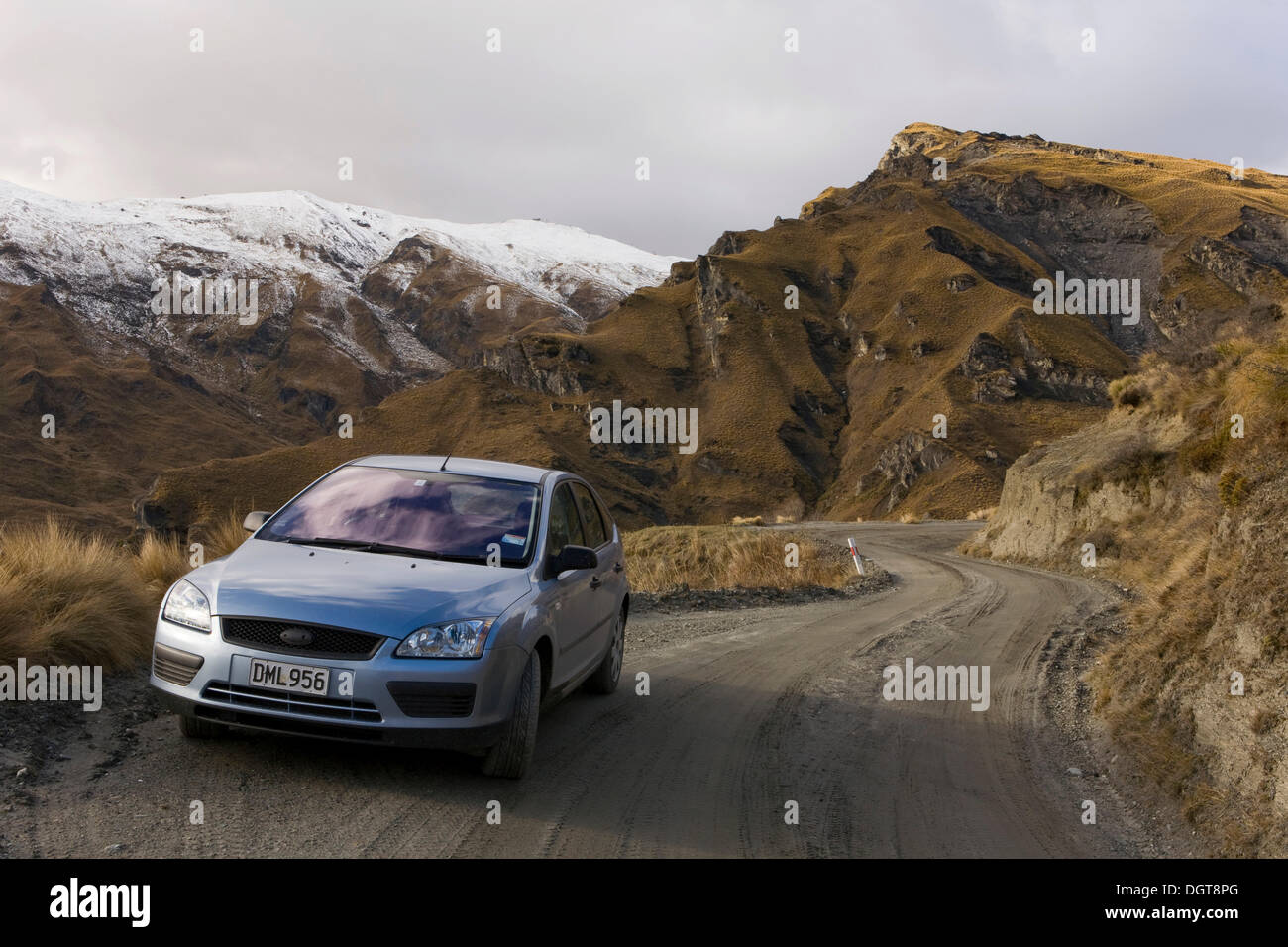 Car on a gravel road in Skippers Canyon, Queenstown, South Island, New Zealand Stock Photo