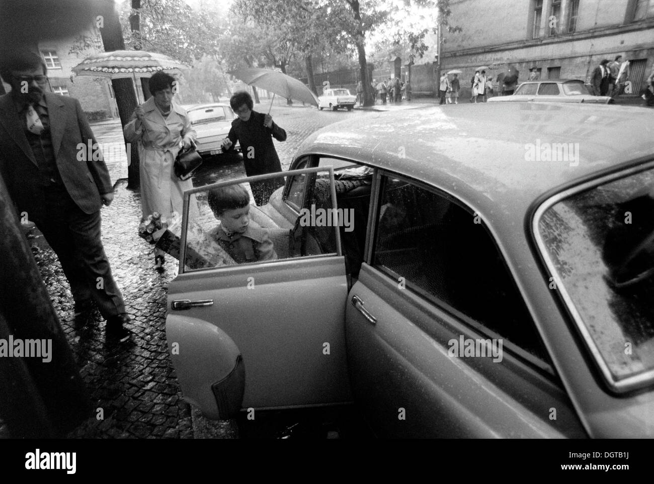 Child with a school cone getting into a Wartburg 311 car, Leipzig, East Germany, historical photograph around 1978 Stock Photo