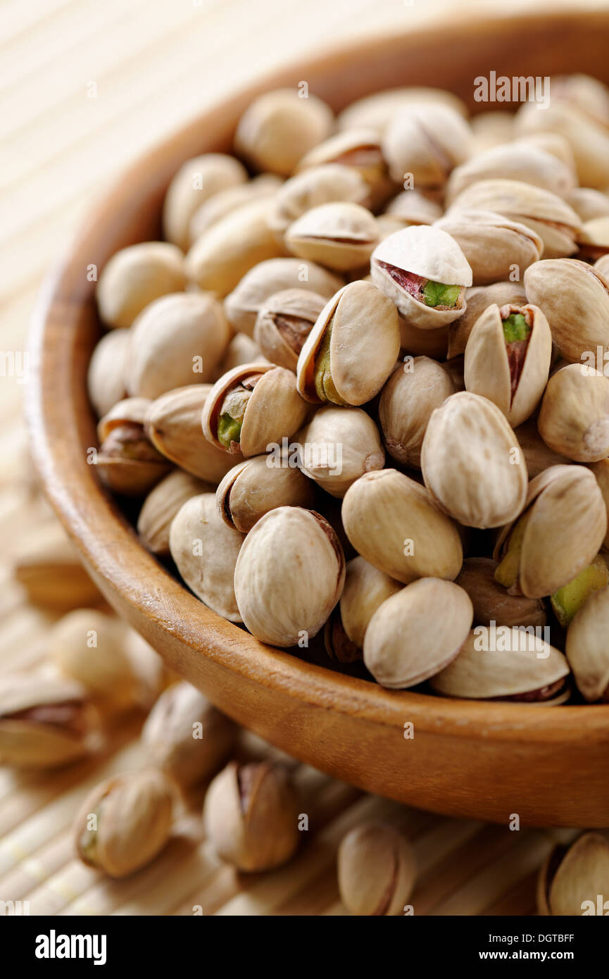 Wooden bowl full of Pistachios Stock Photo Alamy