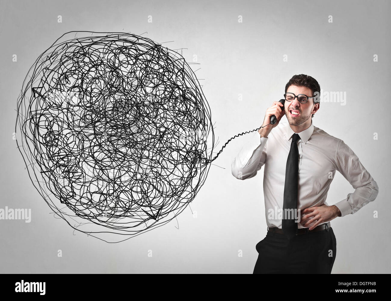 Office worker using a telephone with the wire very tangled Stock Photo