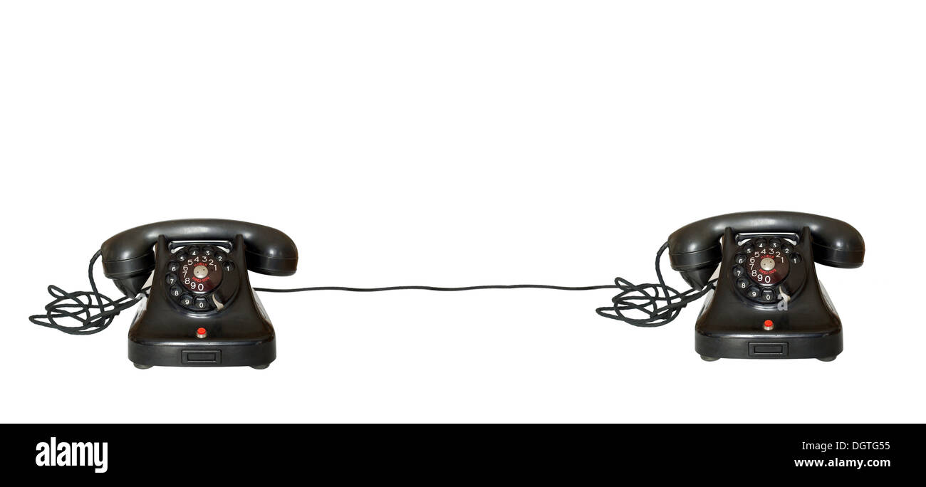 two telephones joint on white background with cable Stock Photo