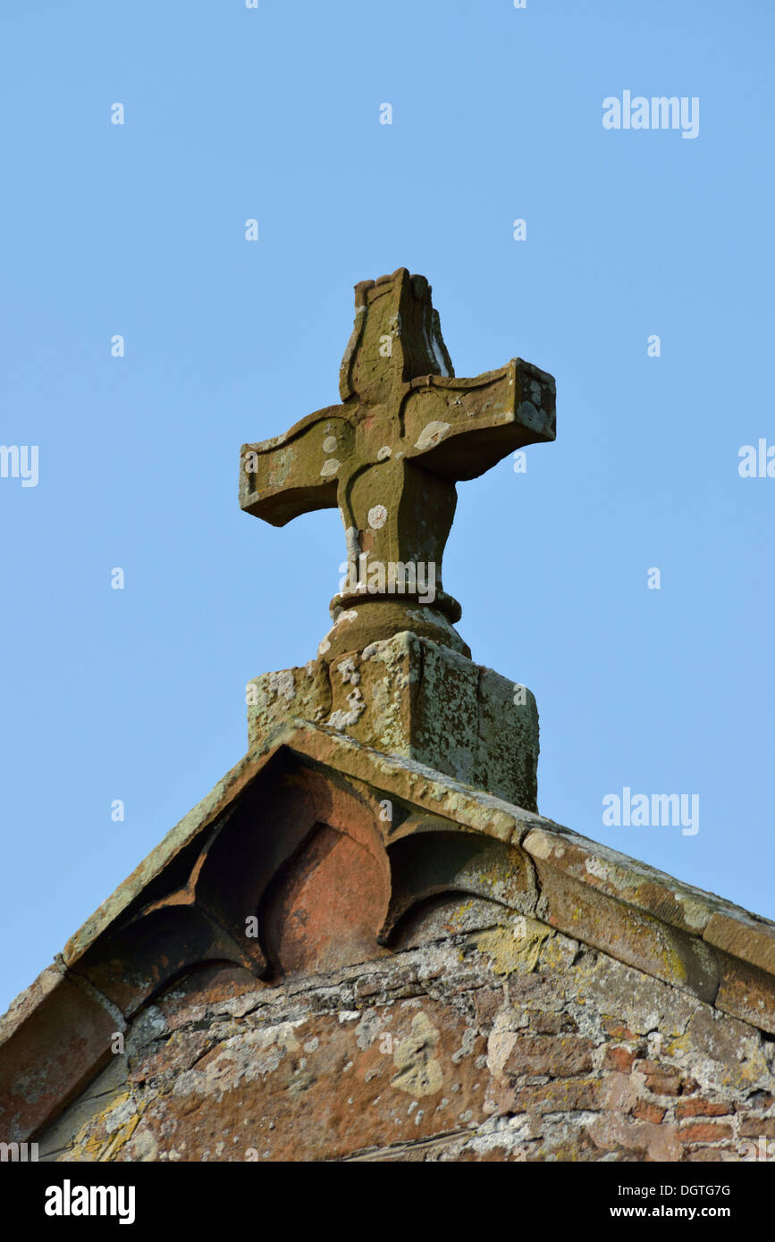 Ornamental stone cross on roof. Church of Saint Cuthbert. Edenhall, Cumbria, England, United Kingdom, Europe. Stock Photo