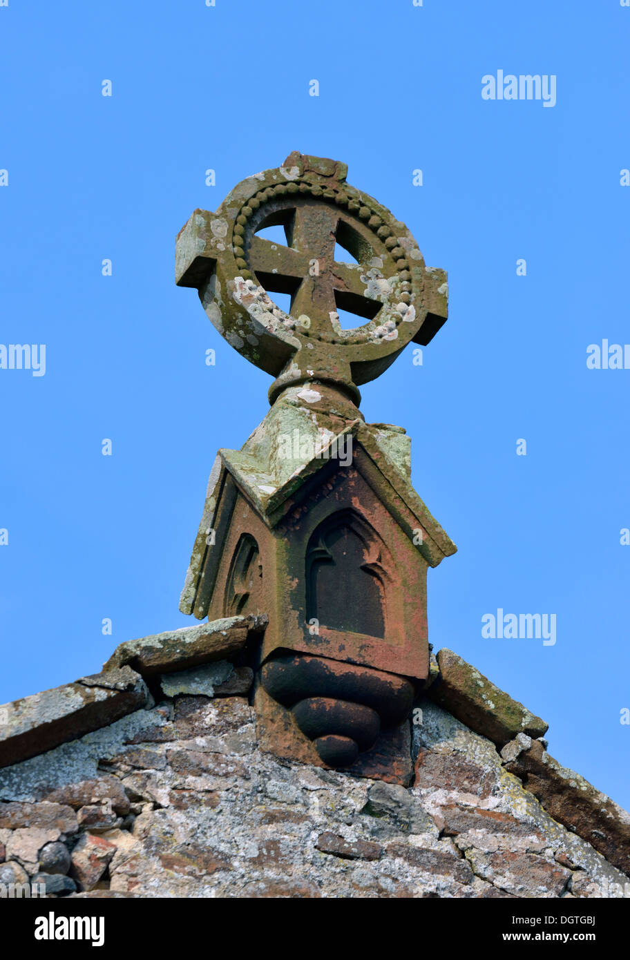 Ornamental stone cross on roof. Church of Saint Cuthbert. Edenhall, Cumbria, England, United Kingdom, Europe. Stock Photo