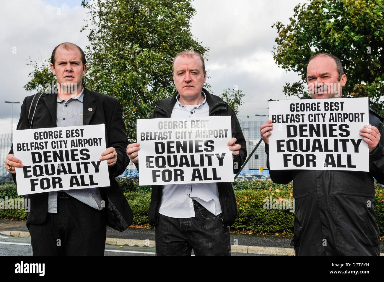 Belfast, Northern Ireland, UK. 25th Oct 2013.  Three members of the Protestant Coalition hold protest banners saying 'George Best Belfast City Airport denies equality for all' after a taxi contract was awarded to Value Cabs following months of sectarian wrangling by previous drivers. Credit:  Stephen Barnes/Alamy Live News Stock Photo