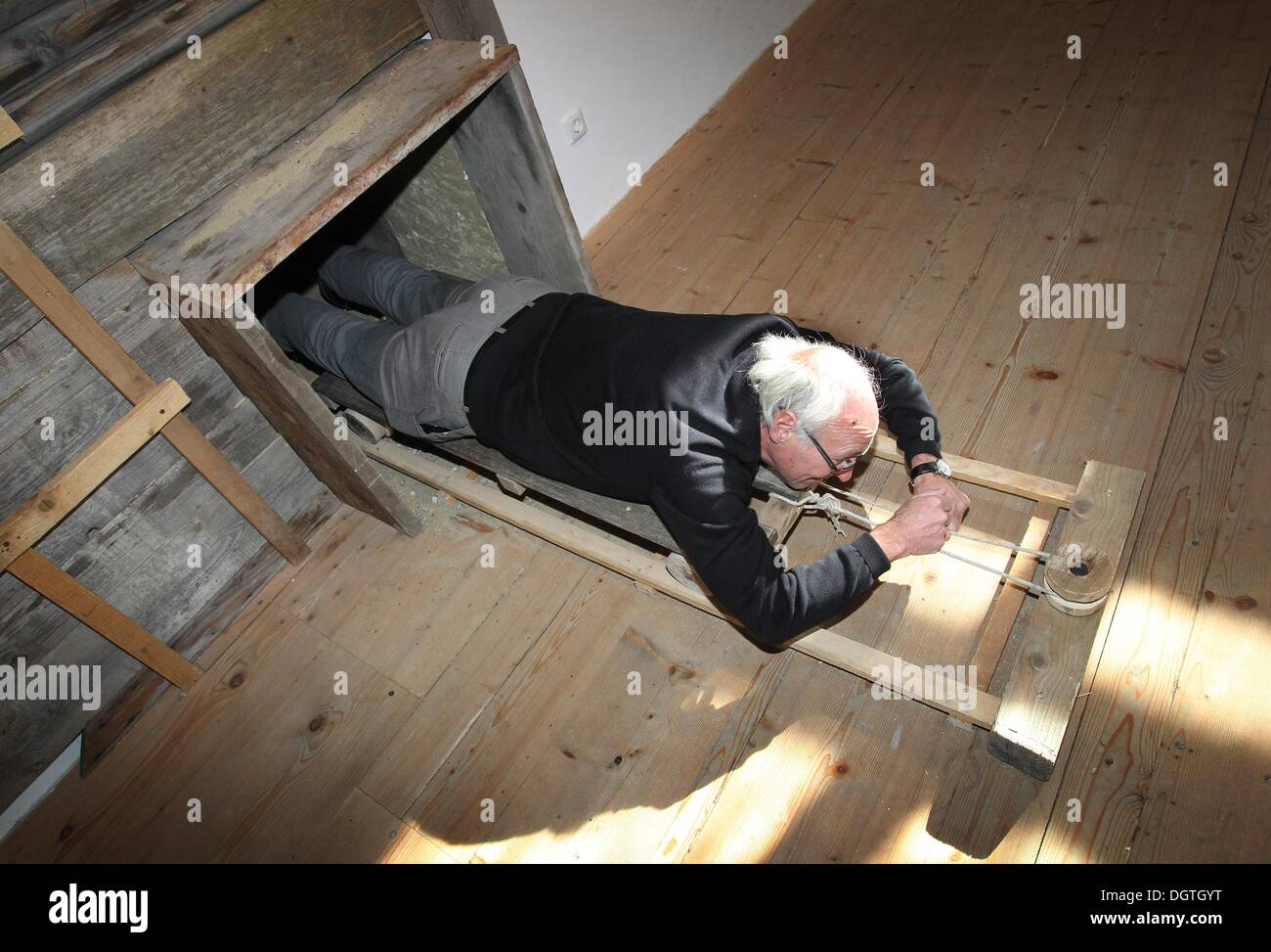 Fuessen, Germany. 17th Oct, 2013. Museum director Thomas Riedmiller pulls himself on a cart through a reconstructed flight tunnel in the Stadtmuseum in Fuessen, Germany, 17 October 2013. A construction of this type was used during the shooting of the film 'The Great Escape' 50 years ago in the Allgau region. Photo: Karl-Josef Hildenbrand/dpa/Alamy Live News Stock Photo