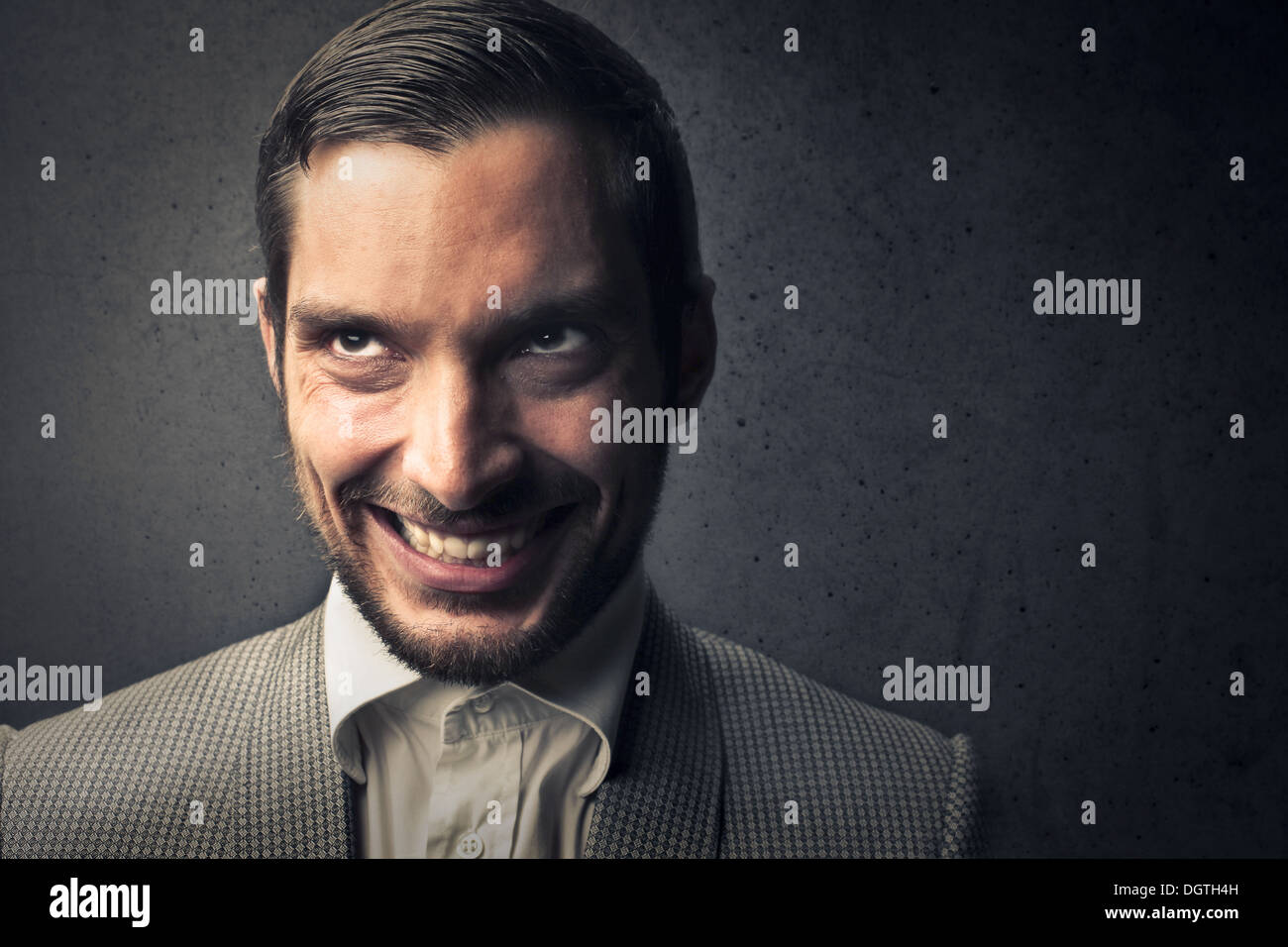 Portrait of an elegant man with a bad smile with a black background Stock Photo