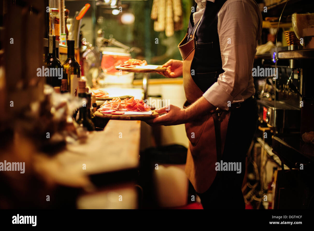 A server carrying a plater of dried meats at La Mascareta restaurant, Venice, Italy. Stock Photo