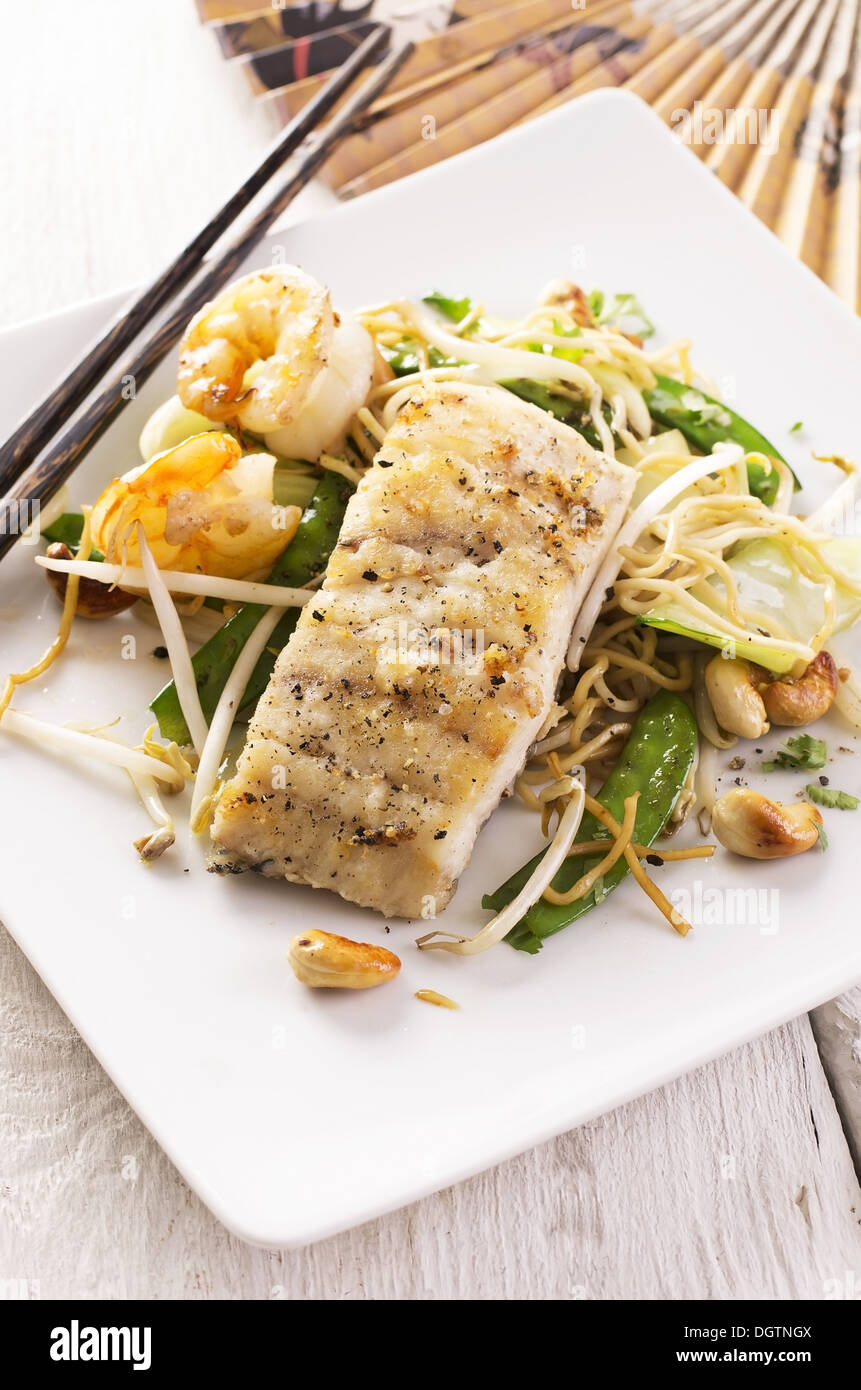 fish fried with noodles and vegetable Stock Photo