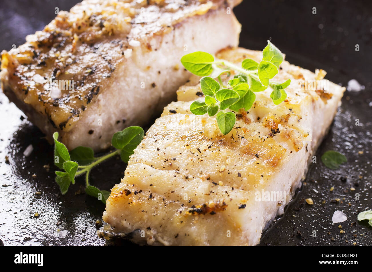 fish fillet fried in the pan Stock Photo - Alamy
