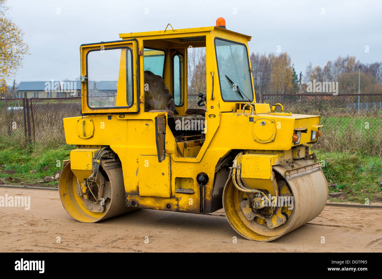 Old yellow road roller waiting for a work Stock Photo
