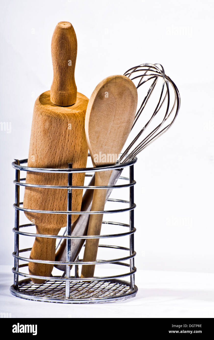 Kitchen utensils in a container on white background Stock Photo
