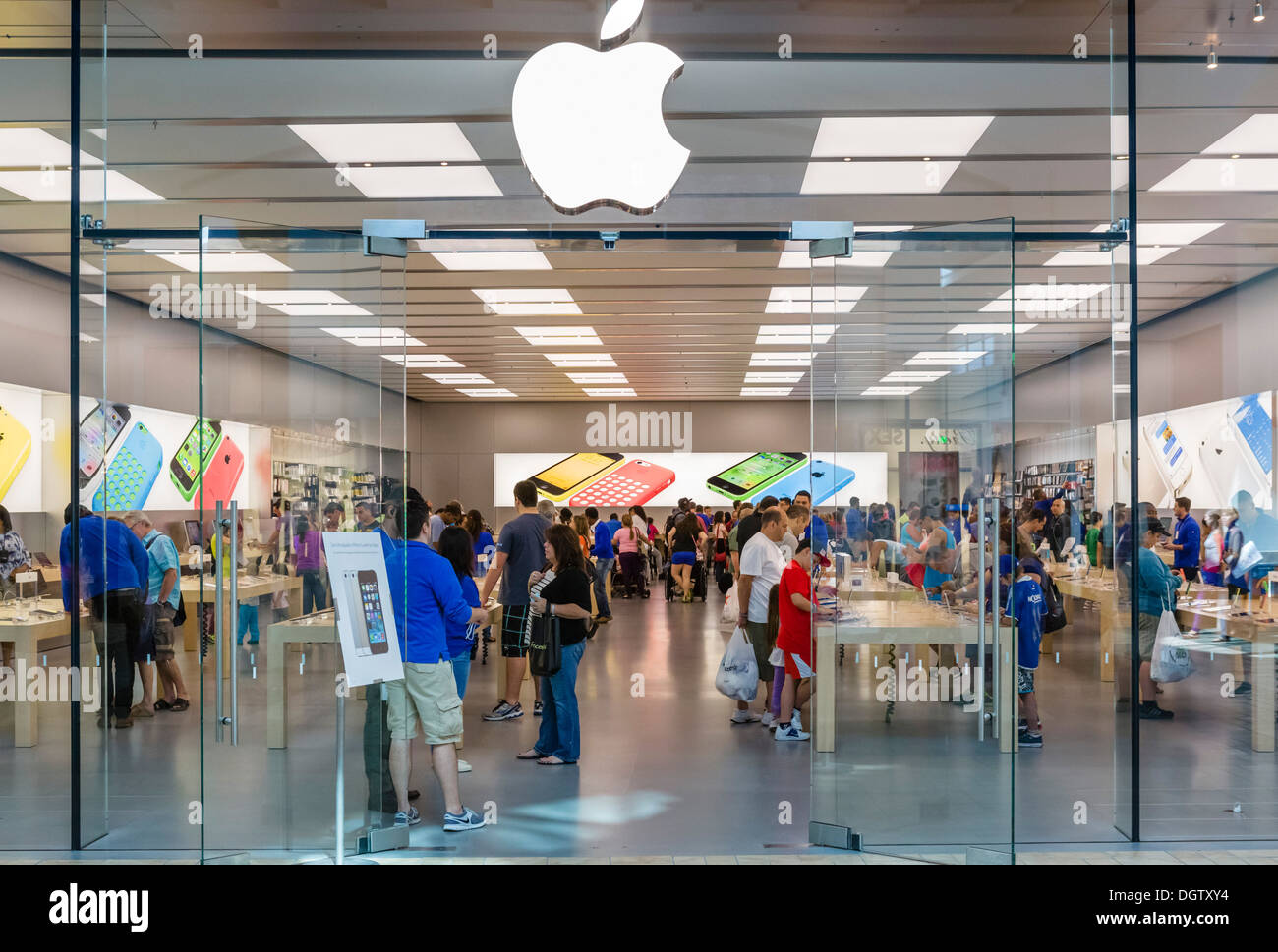 Apple Store signage at Lenox Square in the Buckhead area of Atlanta,  Georgia, with metallic Apple logo on glass reflecting a nearby skyscraper.  (USA Stock Photo - Alamy