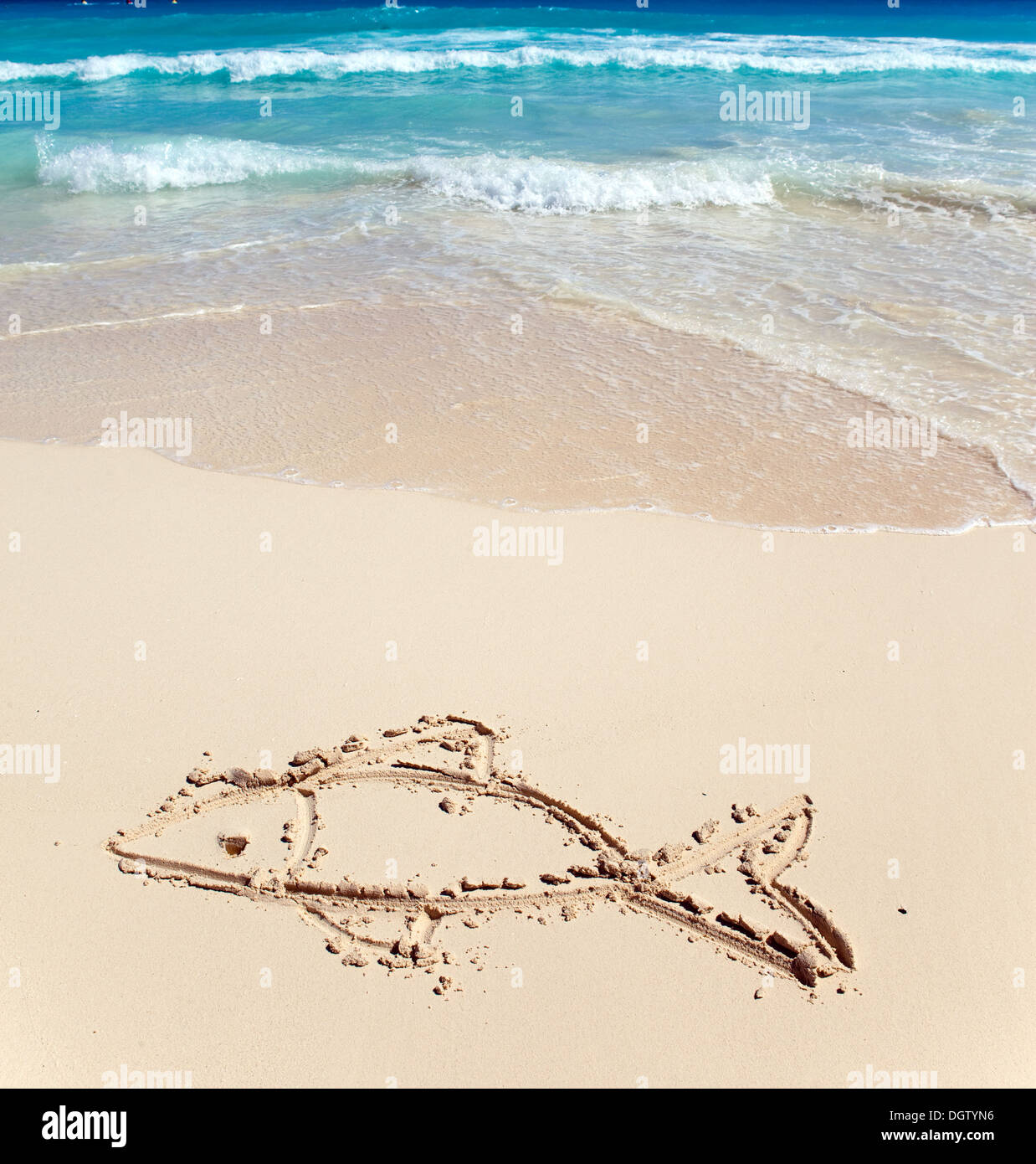Children's picture on sand- a small fish Stock Photo - Alamy