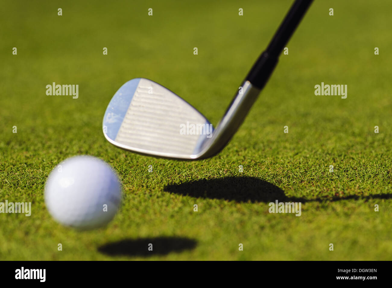 Golf club with a flying golf ball Stock Photo