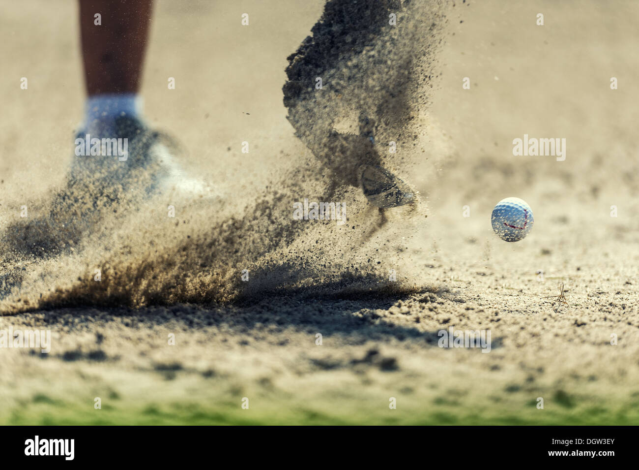 A golf ball is hit out of the bunker Stock Photo
